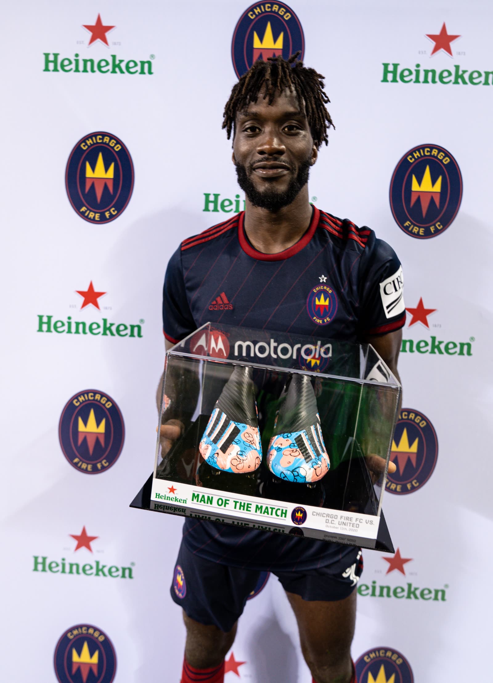 CJ Sapong holding a Man of the Match award after a Chicago Fire match.